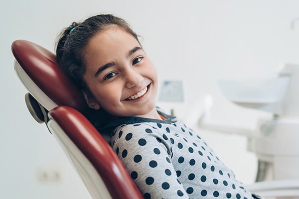 girl in dental chair smiling