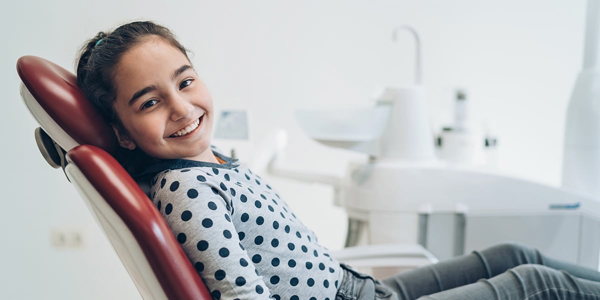 girl in dental chair smiling